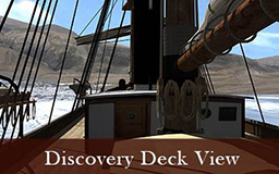 The images in this gallery provide a panoramic view of the landscape surrounding Discovery harbour from the deck of the ship. Rocky hills are visible, as is a tent and the post office cairn built by members of the British Arctic Expedition. Pans of sea ice float in the harbour. Deck details include lifeboats hanging from hooks and the wheelhouse and ships wheel.