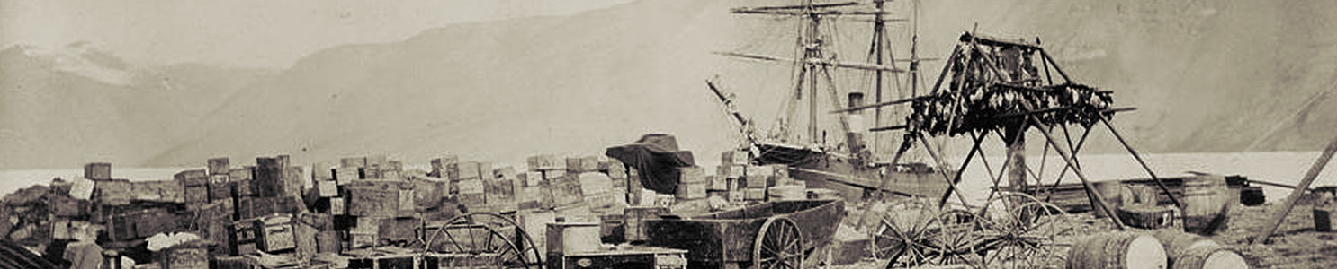 A historic photograph showing expedition supplies on the beach at Fort Conger.