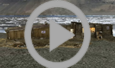An animation that rotates 360 degrees showing all three Peary huts. The rectangular huts all face one another and are constructed of wood that now appears weathered. 
